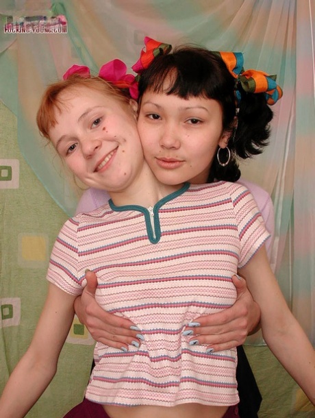 Barely legal dykes share a double ended dildo on their shared bed 71476300